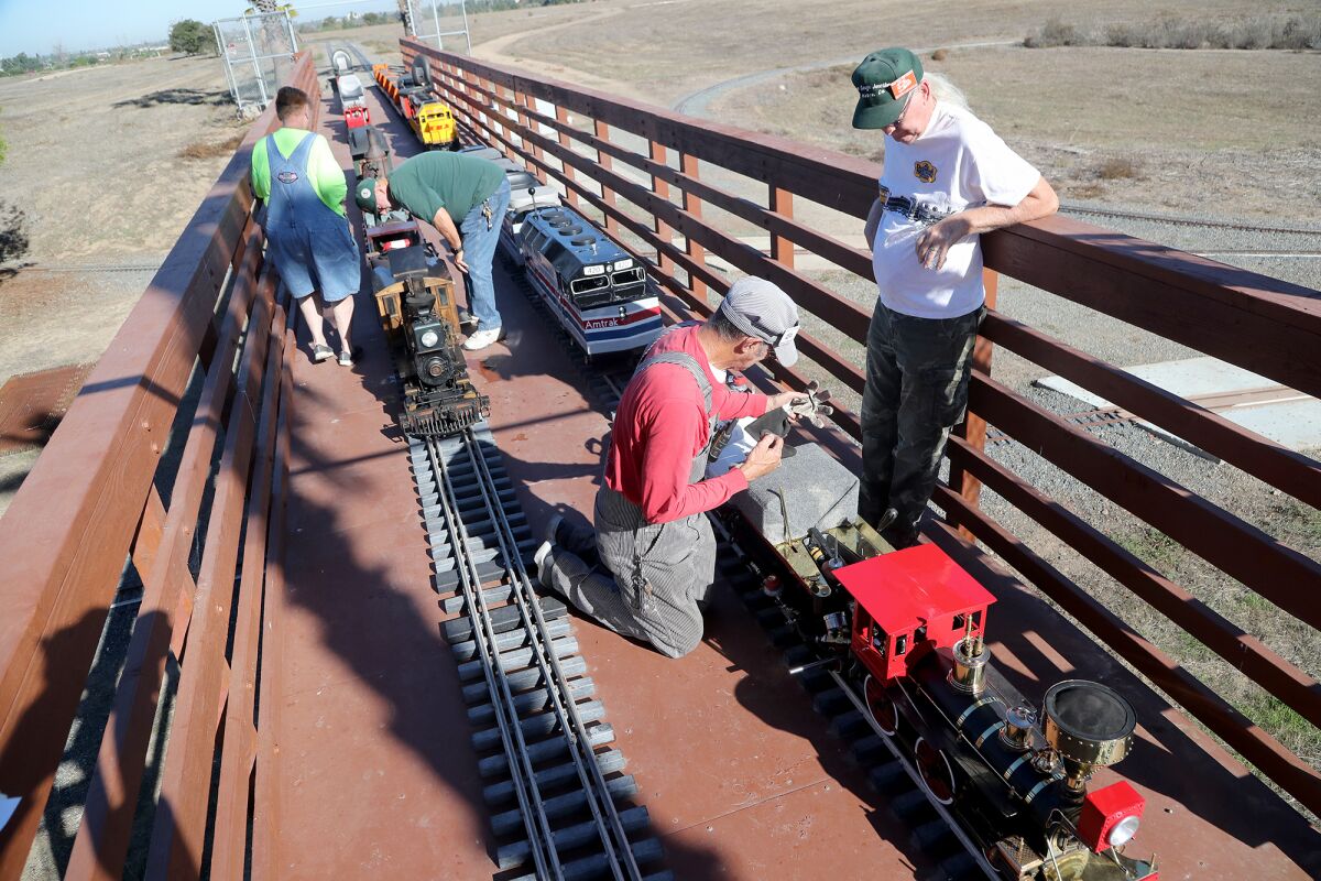 OCME club members fine-tune their model trains ahead of a "Big Toot" celebration Tuesday at Fairview Park in Costa Mesa. 