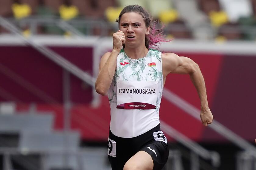 Krystsina Tsimanouskaya, of Belarus, runs in the women's 100-meter run at the 2020 Summer Olympics, Friday, July 30, 2021. Tsimanouskaya alleged her Olympic team tried to remove her from Japan in a dispute that led to a standoff Sunday, Aug. 1, at Tokyo’s main airport. An activist group supporting Tsimanouskaya said she believed her life was in danger in Belarus and would seek asylum with the Austrian embassy in Tokyo. (AP Photo/Martin Meissner)