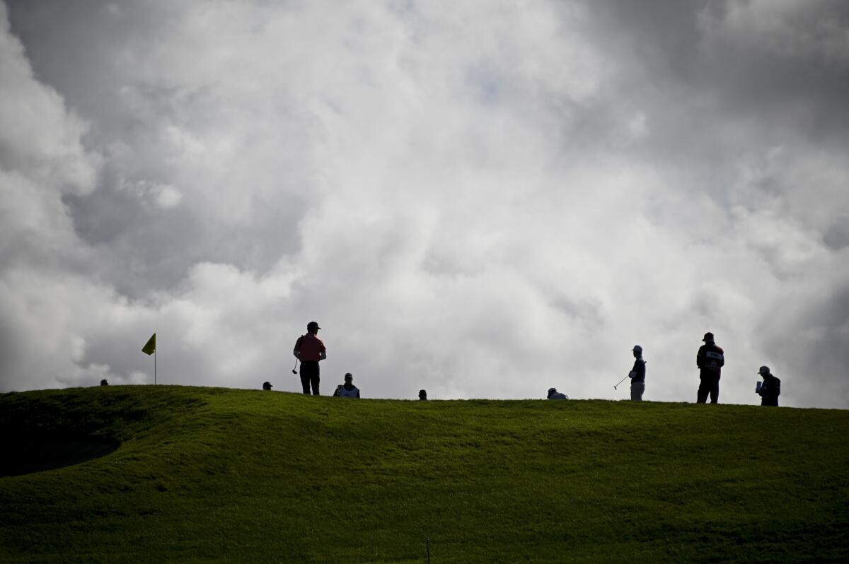 Golfers play the South Course at fanless Torrey Pines in La Jolla during the Farmers Insurance Open in January.