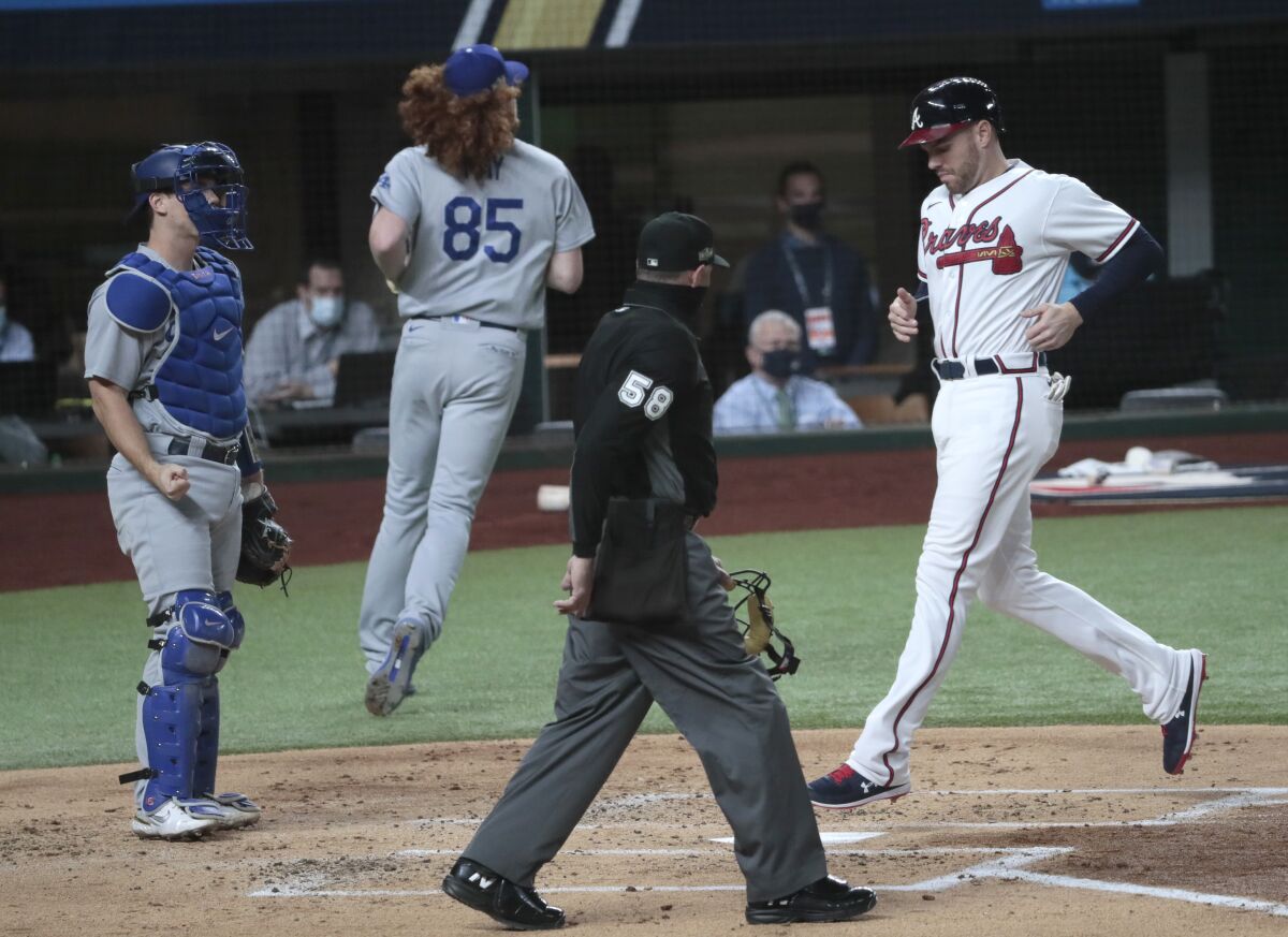 Atlanta's Freddie Freeman scores on a sacrifice fly in the first inning of Game 5 of the NLCS against the Dodgers.