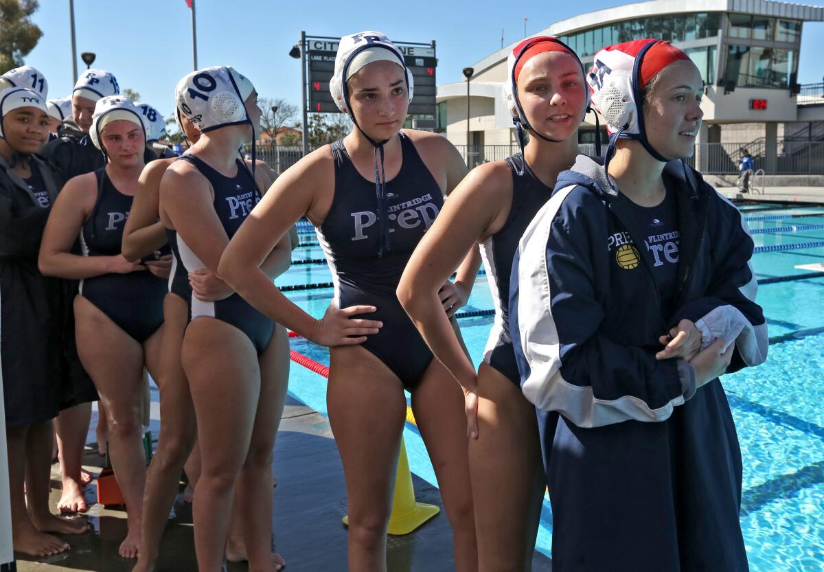 The Flintridge Prep girls water polo team, waiting to shake hands at the end of the game, took second place in the CIF SS Division VII championship match, at the William Woollett Jr. Aquatics Center in Irvine on Saturday, Feb. 16, 2019.