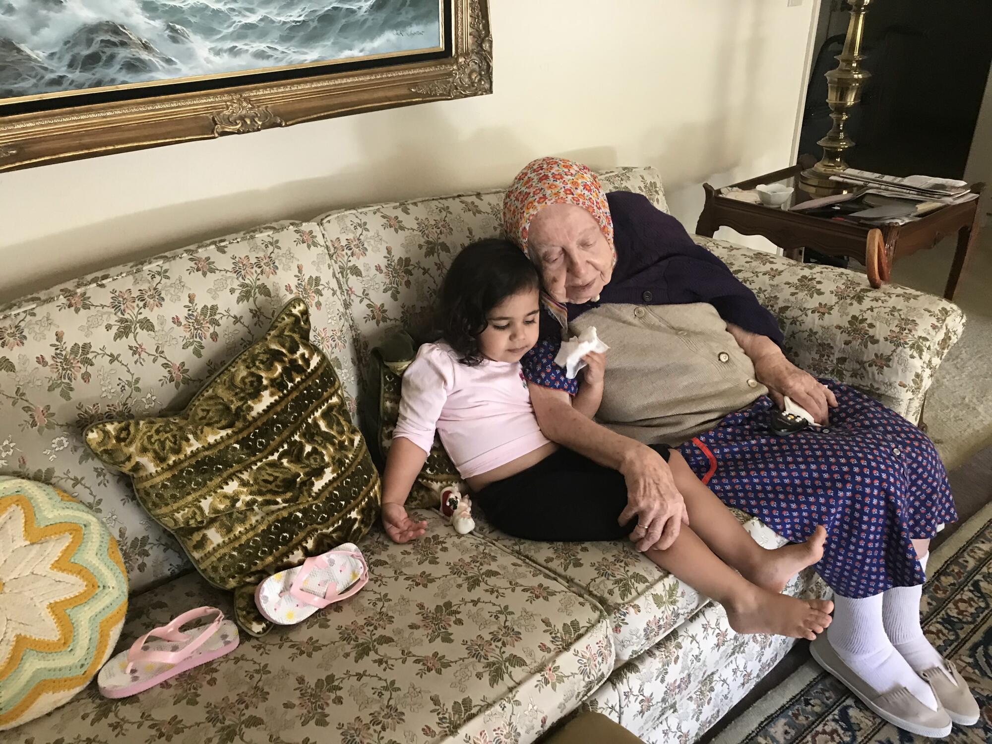 Malia Urdahl, 4, sits with 102-year old Clara Margossian in her Fresno home. 