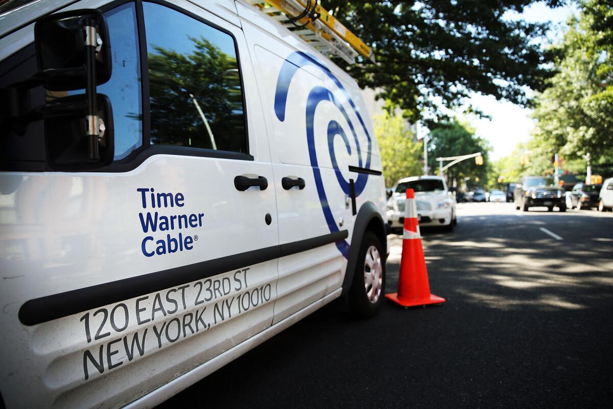 The Federal Communications Commission on Wednesday temporarily halted its review of Comcast's proposed purchase of Time Warner Cable.