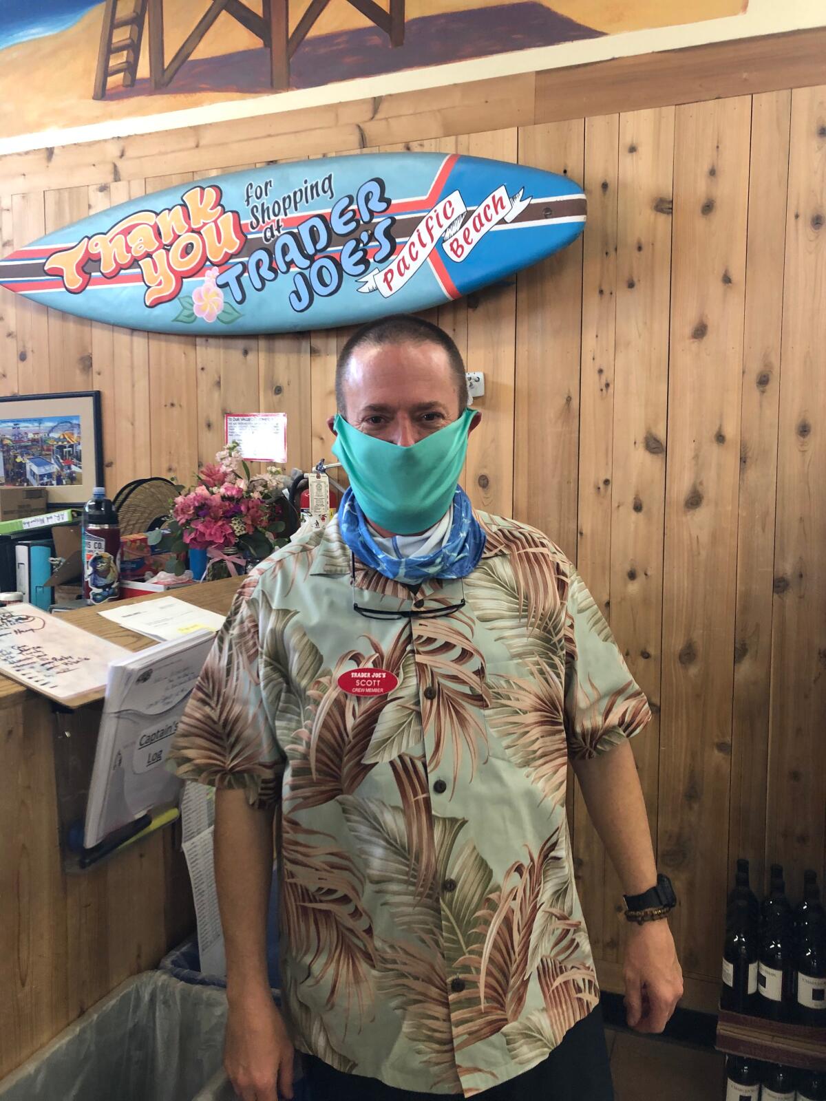 A Trader Joe’s team member in Pacific Beach wears one of Scott Flavell’s protective face masks.