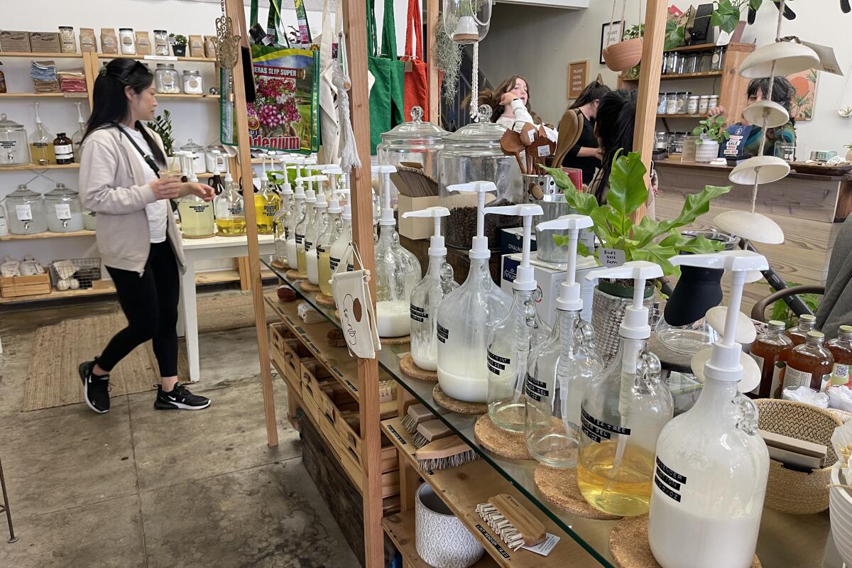A woman walks by the products at BYO Long Beach's Bixby Knolls location.