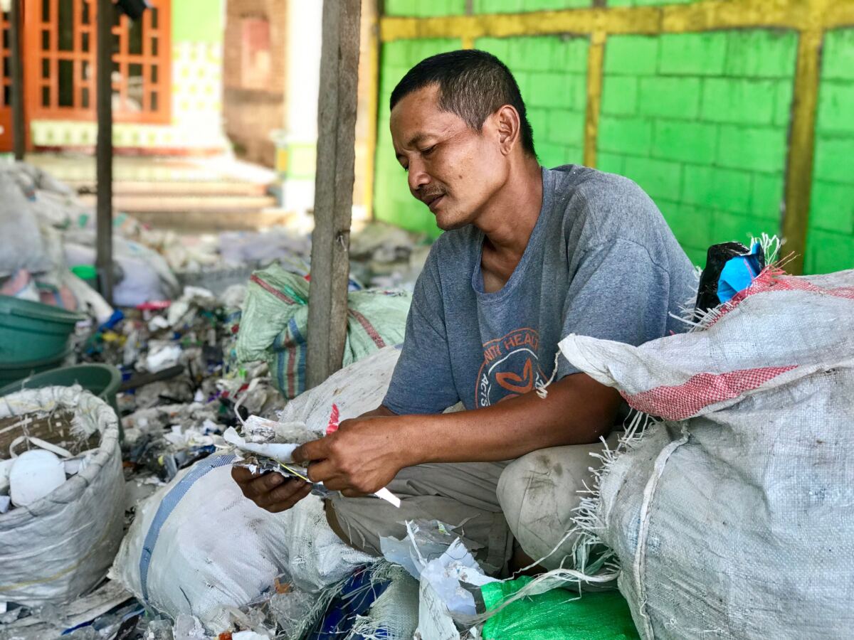 Eko Wahyudi goes through bags of recycling waste at his home facility in Bangun, Indonesia.