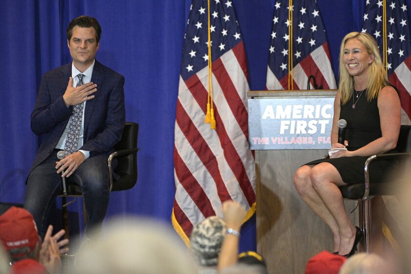 Rep. Matt Gaetz, R-Fla., left, and Rep. Marjorie Taylor Greene, R-Ga., address attendees of a rally, Friday, May 7, 2021, in The Villages, Fla. (AP Photo/Phelan M. Ebenhack)