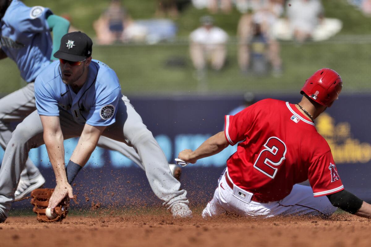 Angels' Andrelton Simmons (2) steals second base as Seattle Mariners' Patrick Wisdom catches the late throw during the second inning of a spring training game on March 4, 2020, in Tempe, Ariz.