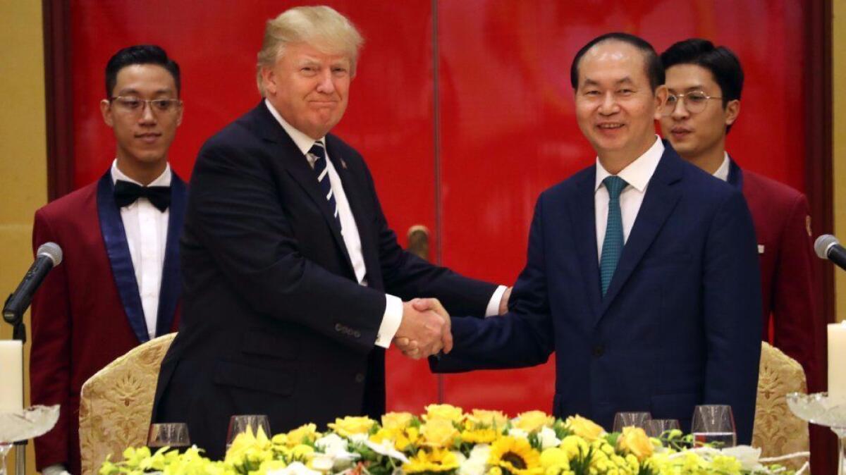 President Trump and Vietnamese President Tran Dai Quang attend a state dinner Saturday in Hanoi, Vietnam, shortly after Trump told reporters about his conversations with Vladimir Putin.