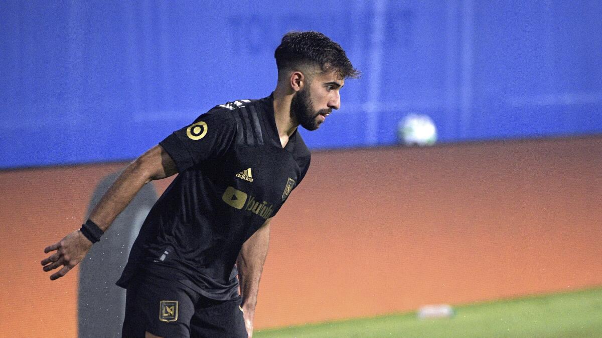 LAFC forward Diego Rossi sets up a play during a match.