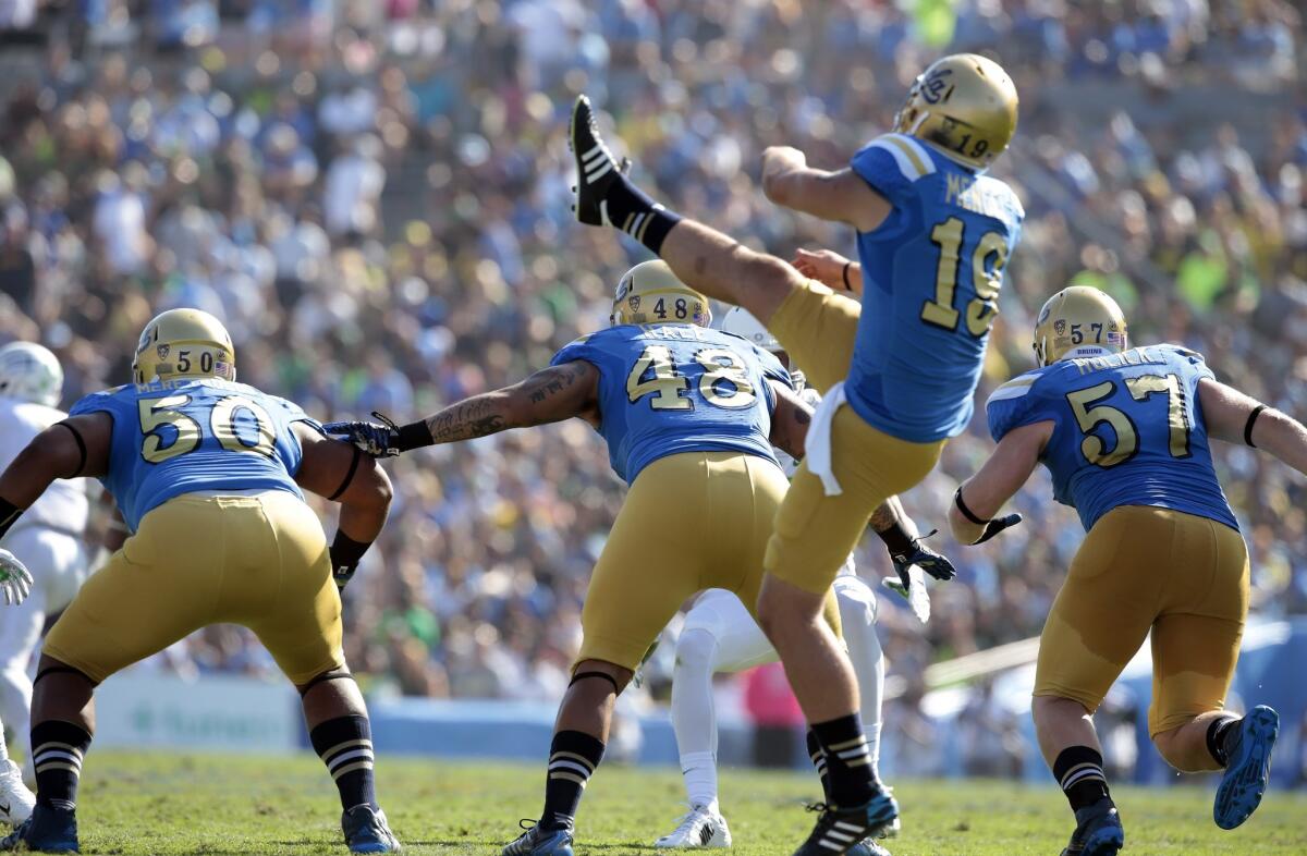 Matt Mengel (19) punts the ball away for the Bruins during UCLA's 42-30 loss to Oregon at the Rose Bowl on Oct. 11.