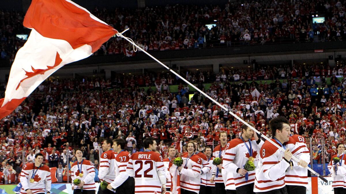 Drew Doughty (8) waves a Canadian flag after his country defeated the United States to take the gold medal at the 2010 Winter Olympics in Vancouver.