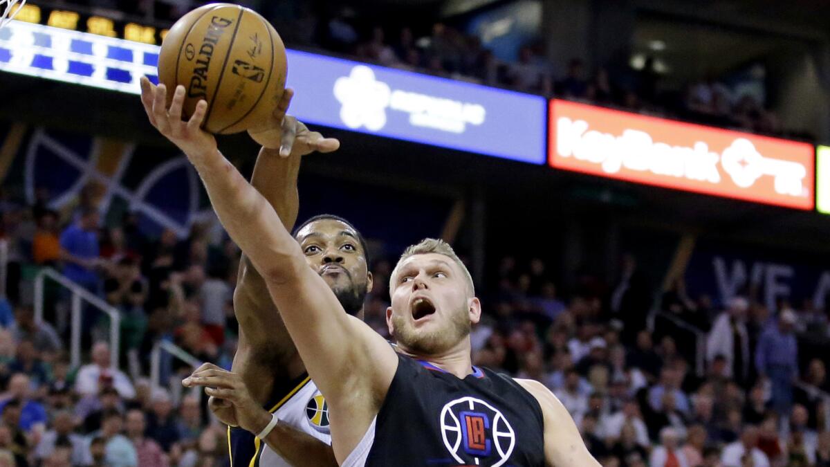 Clippers center Cole Aldrich attempts a layup against Jazz forward Derrick Favors during the second half Friday.
