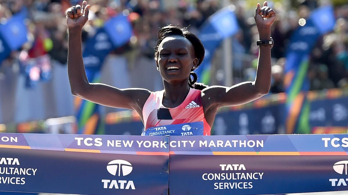 Mary Keitany crosses the finish line Sunday to win her third consecutive New York City Marathon.