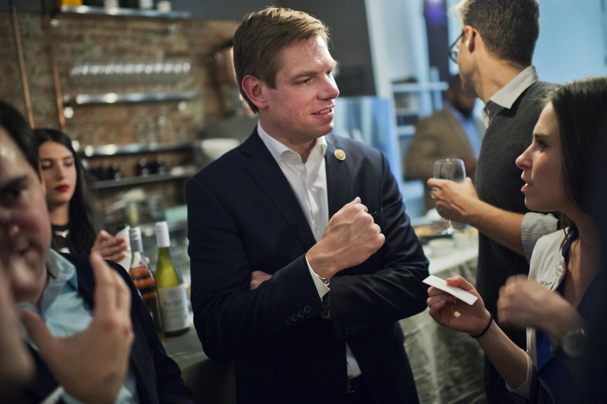 Eric Swalwell mingles at an event.