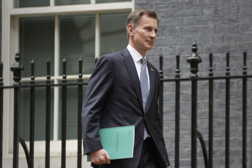 FILE - Britain's Treasury Chief Jeremy Hunt leaves 11 Downing Street on Nov. 17, 2022. Britain is easing banking rules brought in after the 2008 global financial crisis in a bid to attract investment and secure London’s status as Europe’s leading finance center. Hunt said Friday, Dec. 9, 2022, that the changes, which follow Britain’s departure from the European Union in 2020, will make Britain “one of the most open, dynamic and competitive financial services hubs in the world.” (AP Photo/Kin Cheung)