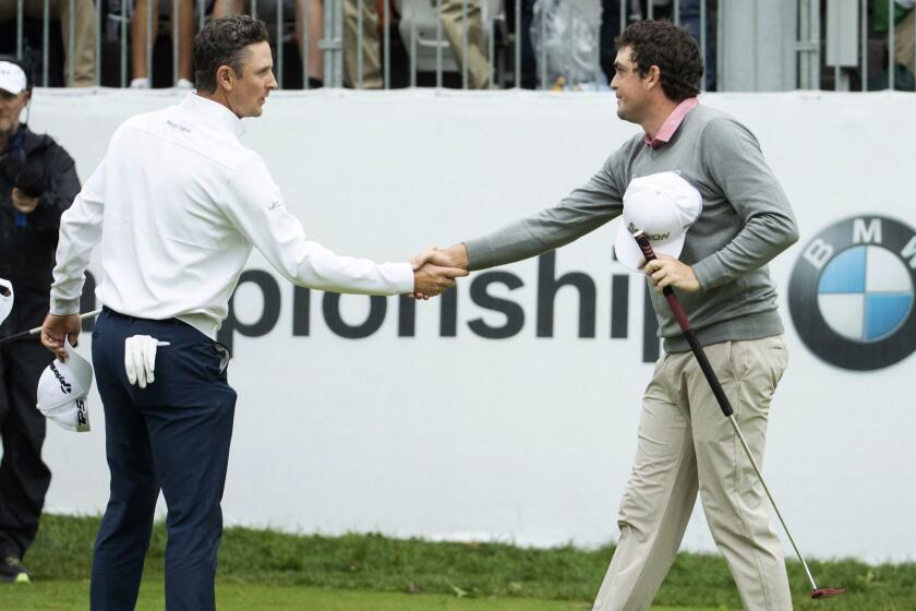 Justin Rose, of England, left, and Keegan Bradley shakes hands after the BMW Championship golf tournament at the Aronimink Golf Club, Monday, Sept. 10, 2018, in Newtown Square, Pa. Bradley held off Rose in a sudden-death playoff to win the rain-plagued BMW Championship for his first PGA Tour victory in six years. (AP Photo/Chris Szagola)