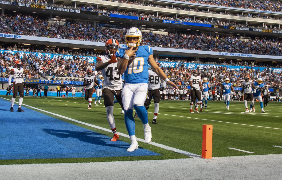  Chargers quarterback Justin Herbert  scores on a nine-yard rushing play against the Browns.