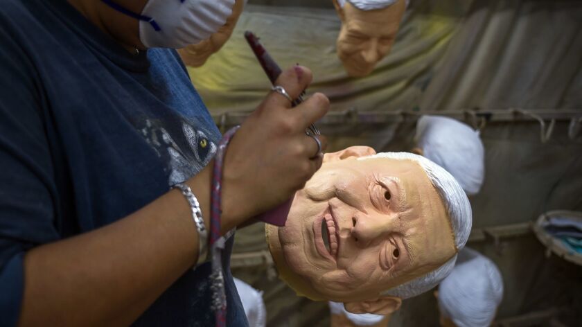 A worker puts the finishing touches on a latex mask of Mexican presidential candidate Andres Manuel Lopez Obrador, a populist leading the polls by double digits.