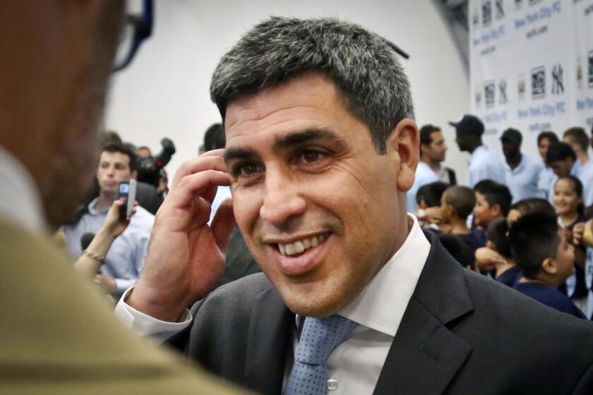 FILE - Former U.S. national team soccer captain Claudio Reyna reacts during an interview on May 22, 2013.