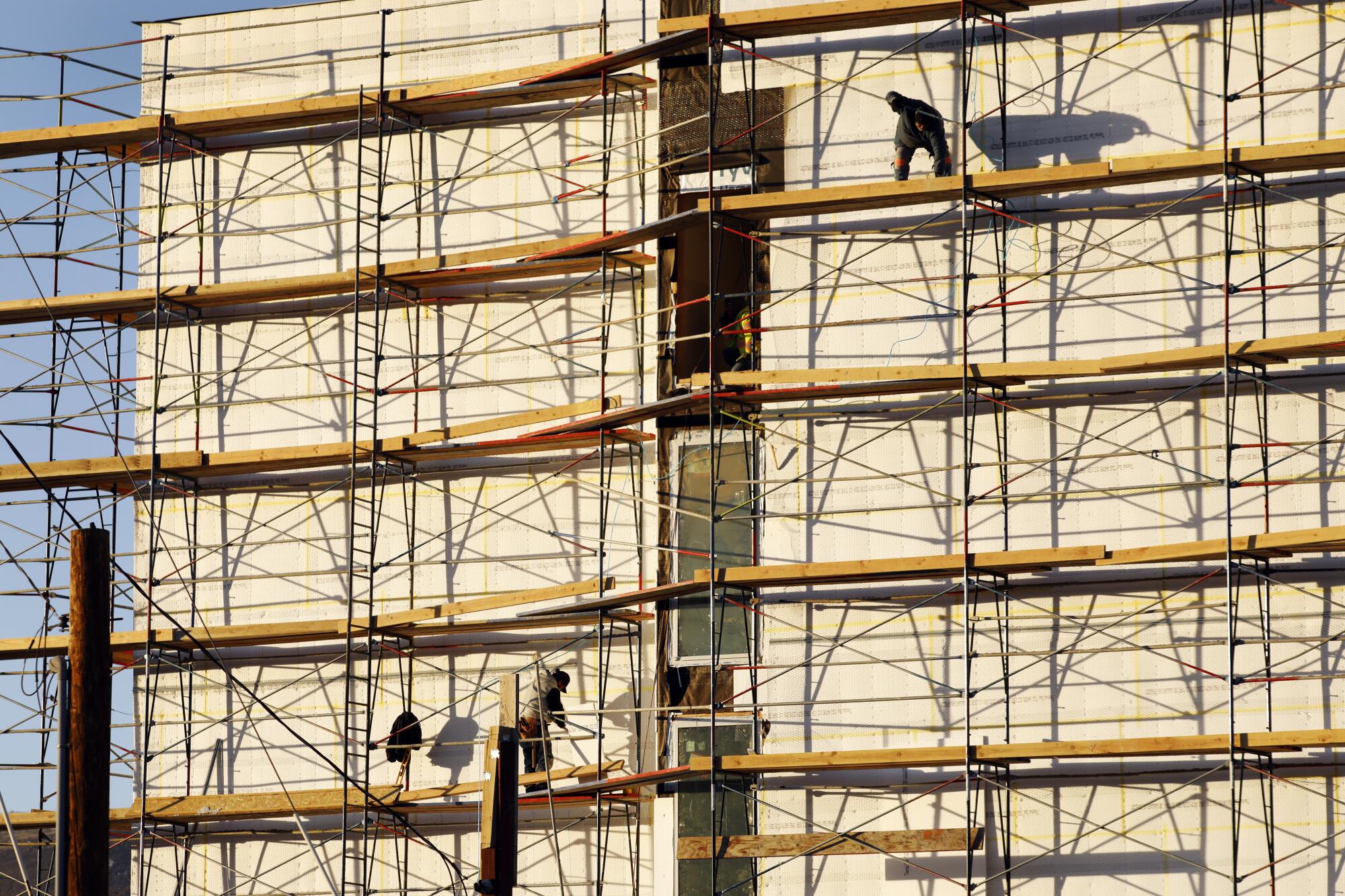 Construction workers on scaffolding.