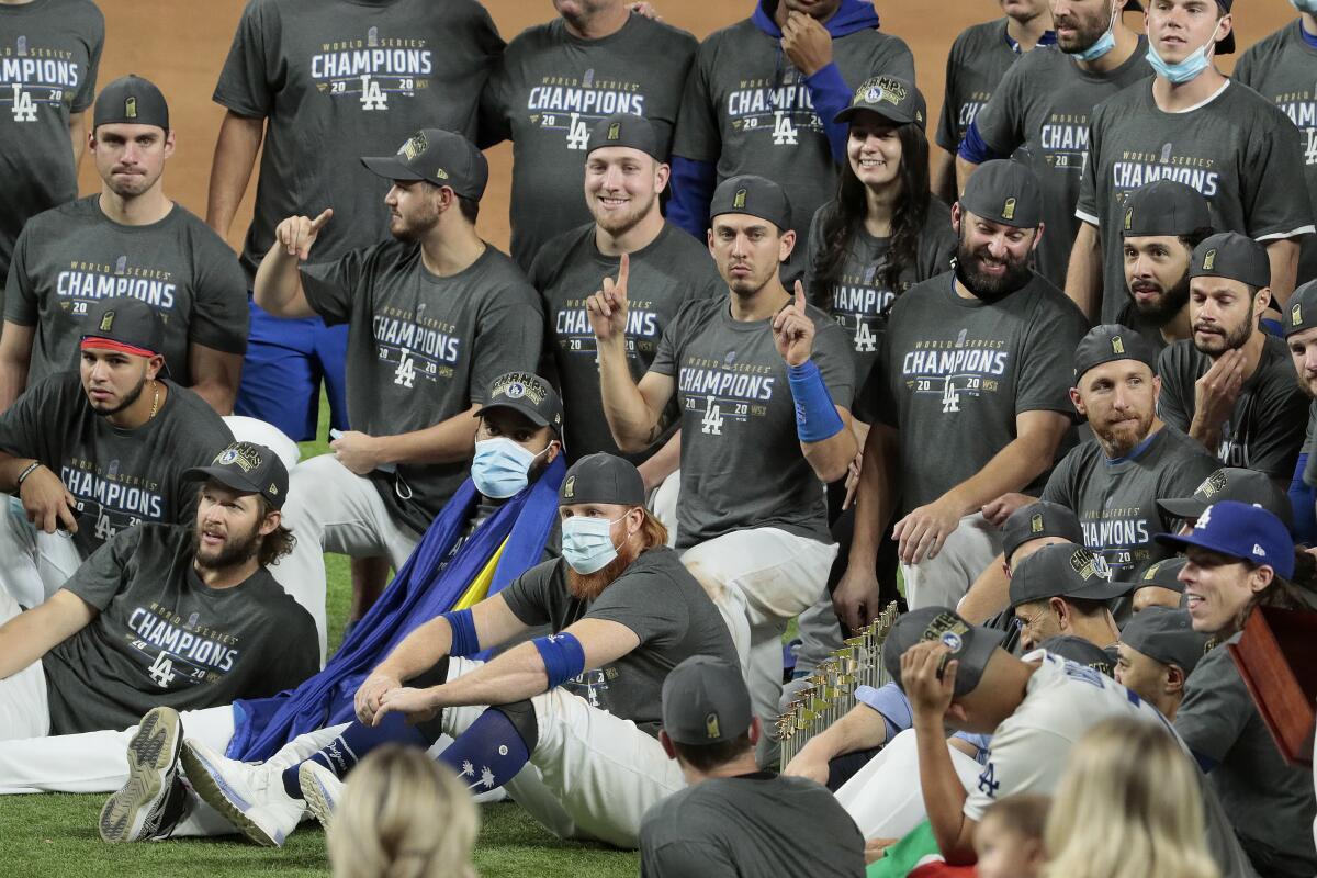 Dodgers players wear their championship hats and T-shirts while celebrating their World Series victory.