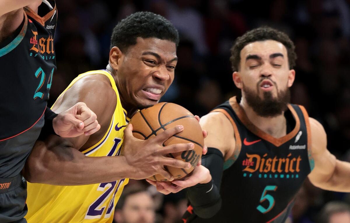 Lakers forward Rui Hachimura drives to the basket against Wizards guard Tyus Jones on Thursday night at Crypto.com Arena.