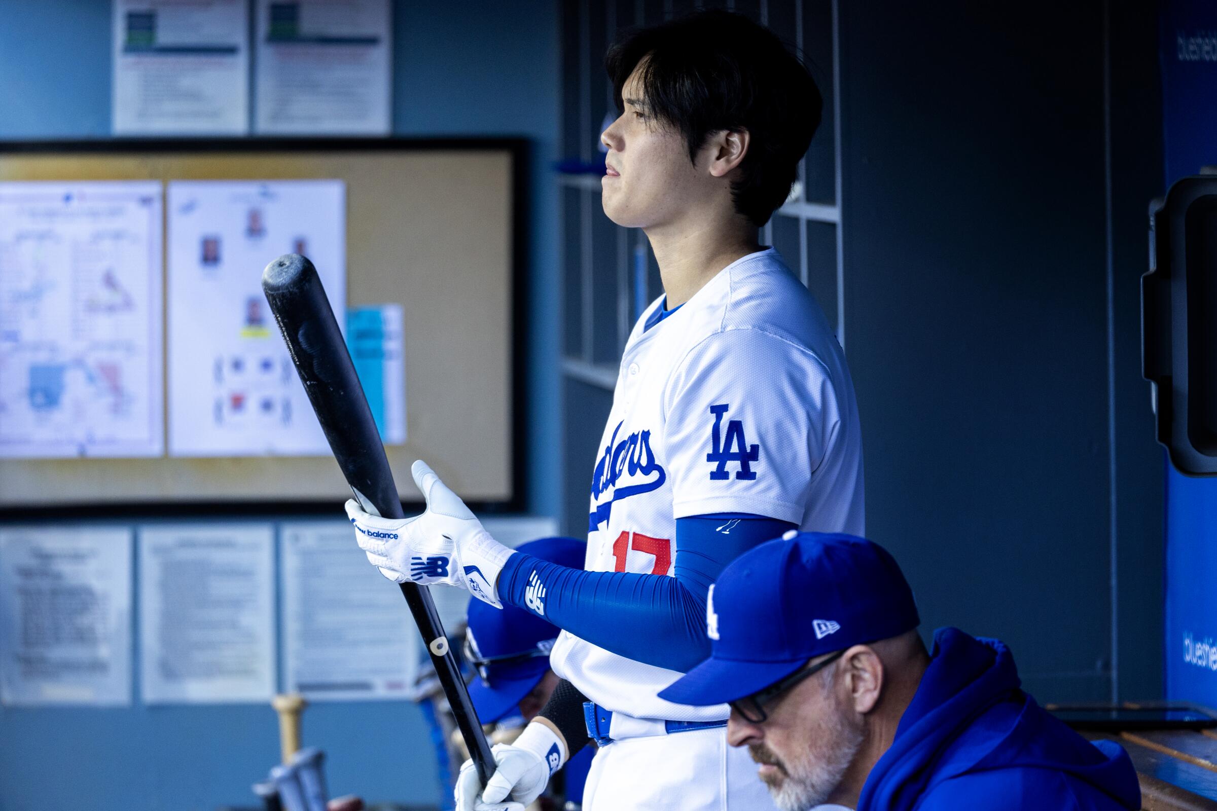 Shohei Ohtani stands in the dugout during a game against the St Louis Cardinals at Dodger Stadium on March 31.