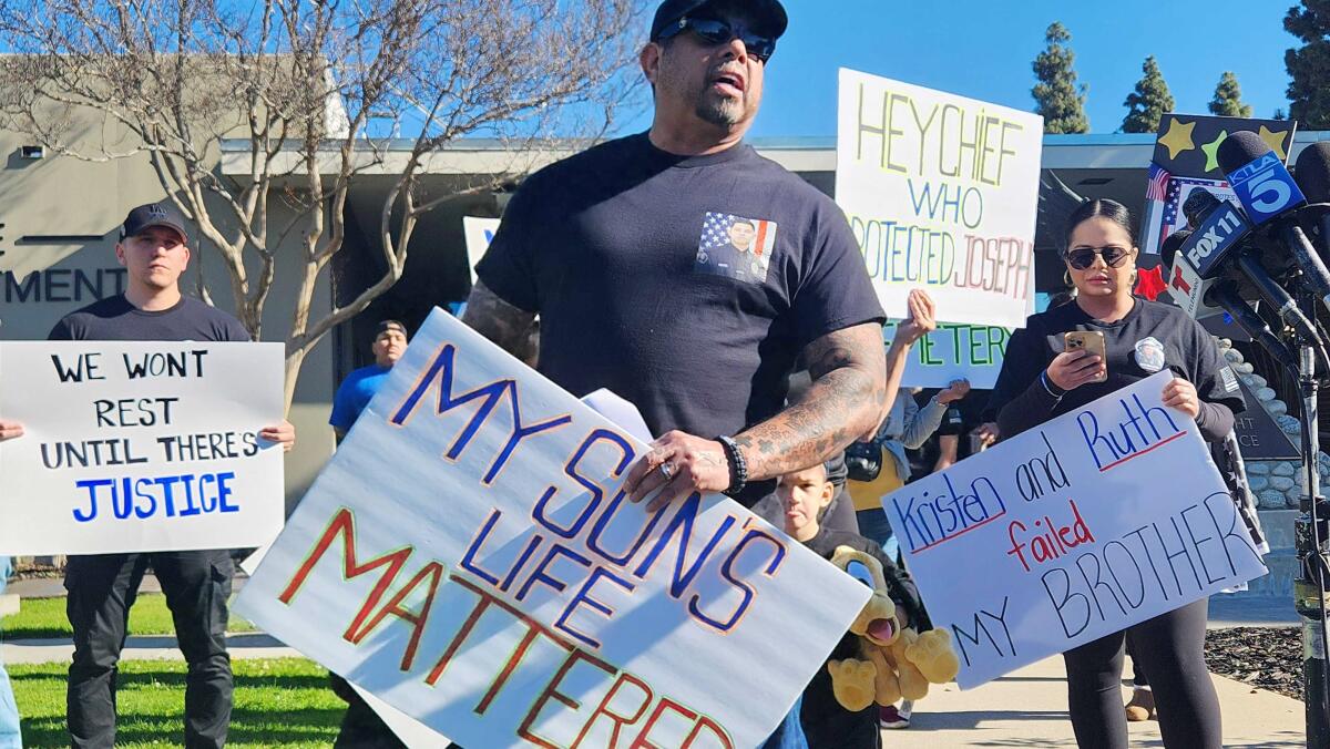 A man holds a sign that says "My son's life mattered."