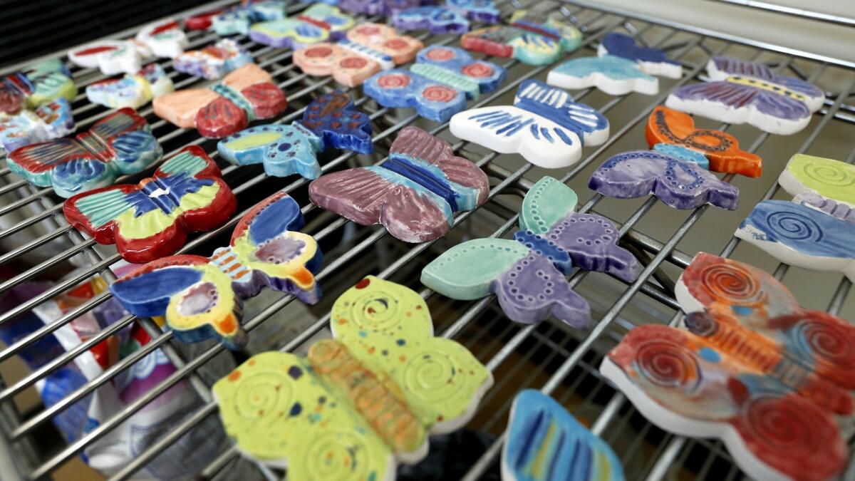 Ceramic butterflies decorated by high school students as part of the Butterfly Project are displayed at the Merage Jewish Community Center of Orange County in Irvine.