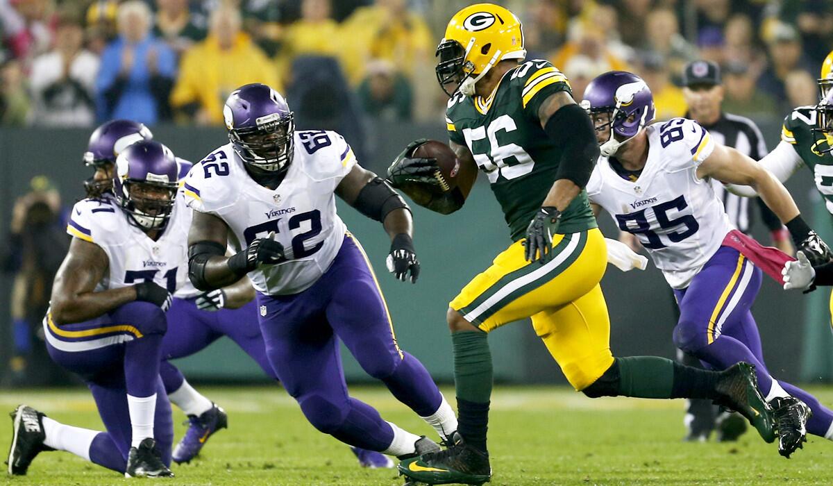 Packers outside linebacker Julius Peppers runs back an interception 49 yards for a touchdown against the Vikings.