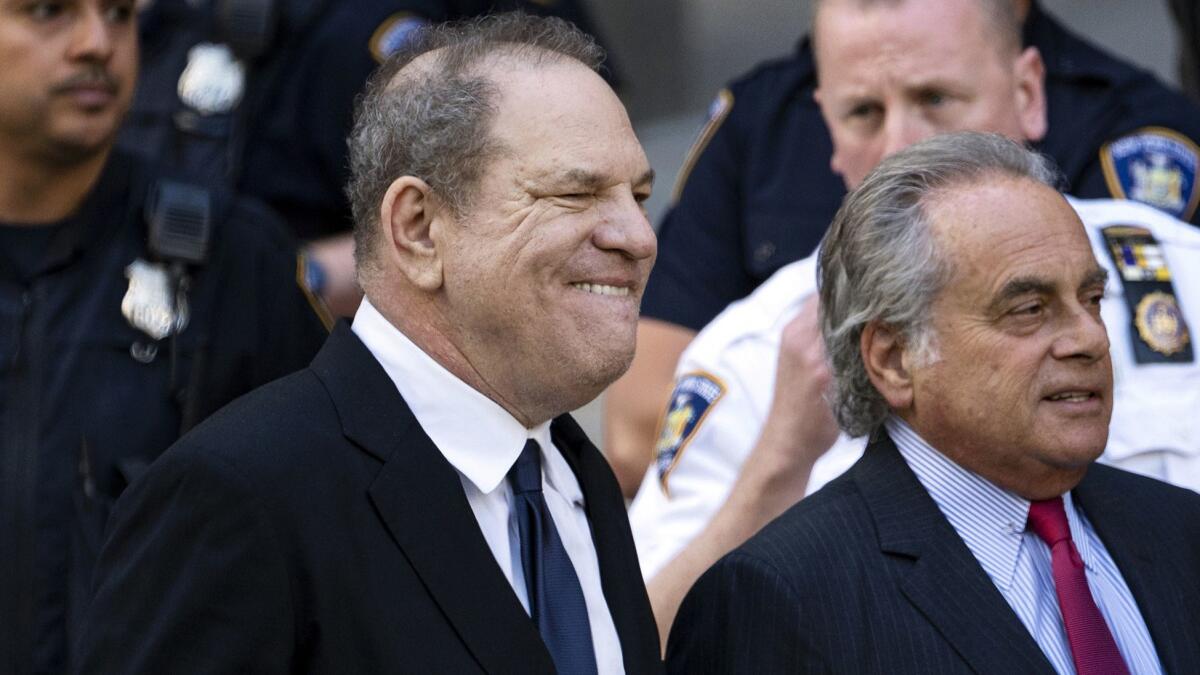 Harvey Weinstein, left, leaves a Manhattan courthouse Monday alongside his attorney Benjamin Brafman.