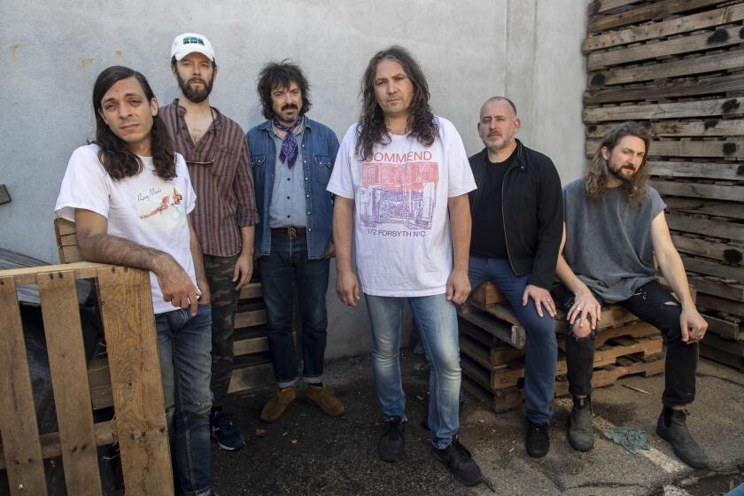 BURBANK, CA - October 05 2021: The War on Drugs band members, left to right, Anthony LaMarca, David Hartley, Charlie Hall, Adam Granduciel, Jon Natchez and Robbie Bennett sit for portraits on Tuesday, Oct. 5, 2021 in Burbank, CA. (Brian van der Brug / Los Angeles Times)