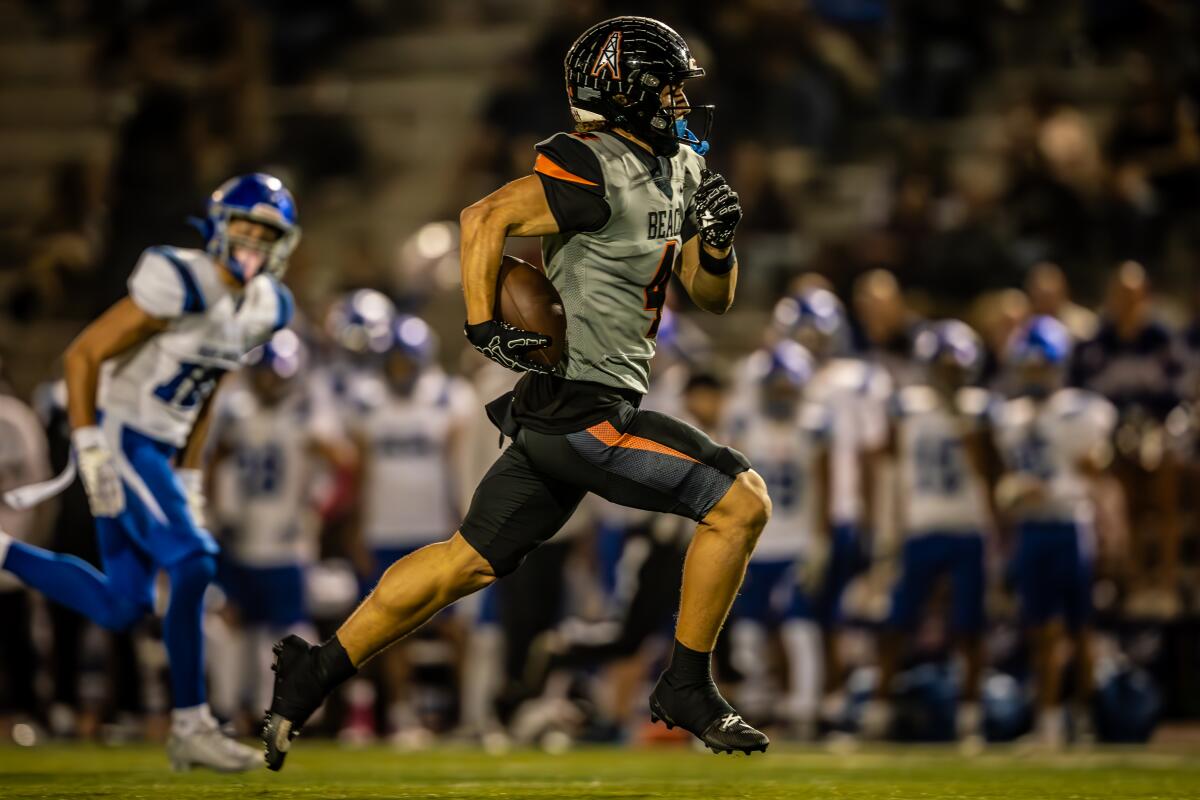 Huntington Beach's Troy Foster scores a 59-yard receiving touchdown from Brady Edmunds in the first quarter versus La Habra.