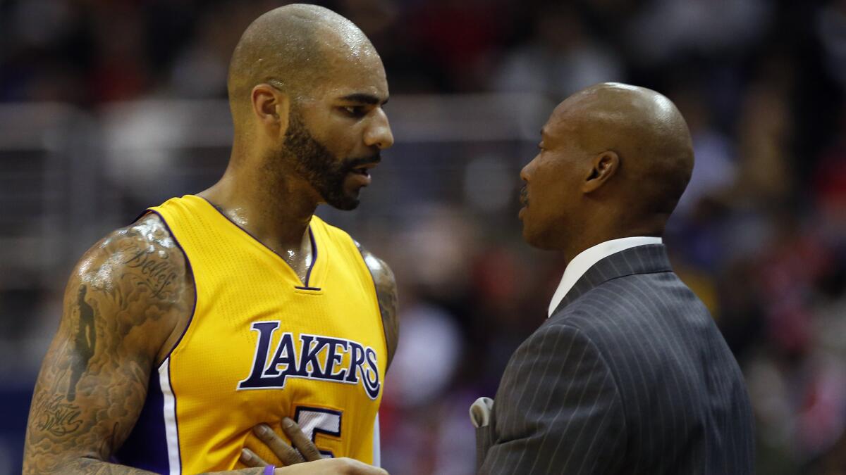 Lakers forward Carlos Boozer speaks with Coach Byron Scott during a loss to the Washington Wizards last week.