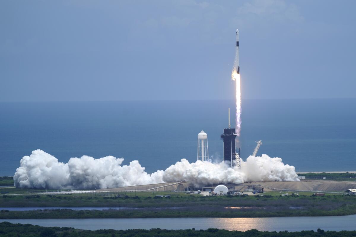 A SpaceX Falcon 9 rocket with a Dragon 2 spacecraft lifts off on pad 39A at the Kennedy Space Center for a re-supply mission to the International Space Station from Cape Canaveral, Fla., Thursday, June 3, 2021. (AP Photo/John Raoux)