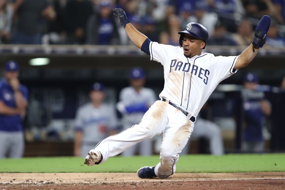 Francisco Mejia scores on a wild pitch during the ninth inning of the Padres' game against the Los Angeles Dodgers on Wednesday at Petco Park.