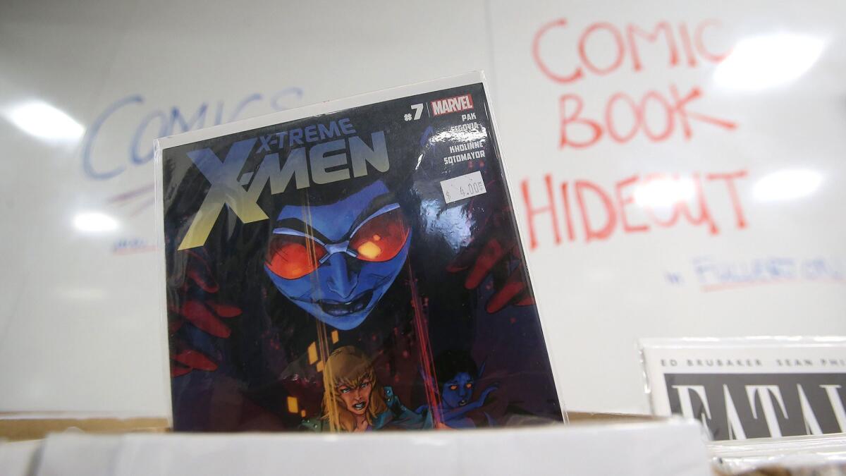An X-Men comic is offered for a dollar by Comic Book Hideout at the first Fan Con at the Laguna Beach High School library on Thursday night.