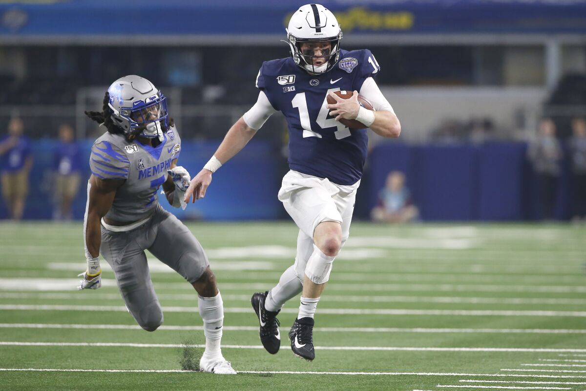 FILE - In this Dec. 28, 2019, file photo, Penn State quarterback Sean Clifford (14) carries the ball as Memphis defensive back Chris Claybrooks (7) closes in during the first half of the NCAA Cotton Bowl college football game, in Arlington, Texas. It hasn’t been an ideal time for No. 9 Penn State to install a new offense, but the Nittany Lions believe they have the pieces in place to be one of the better teams in the country. (AP Photo/Ron Jenkins, File)
