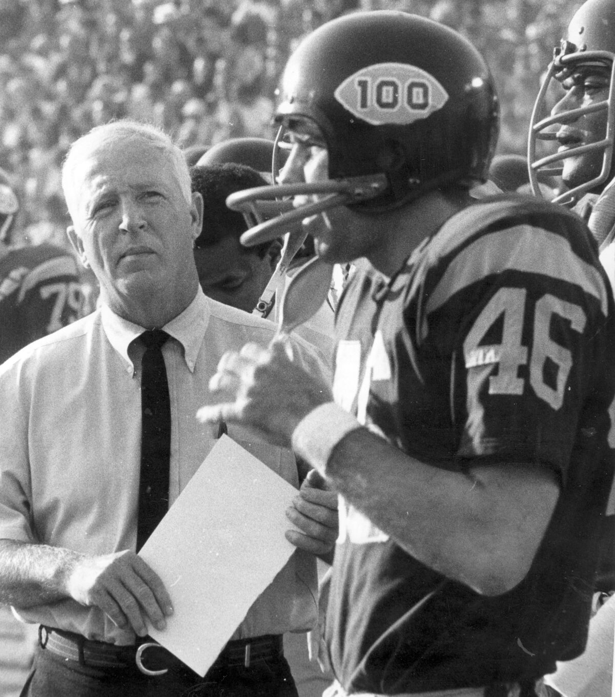 USC coach John McKay talks with defensive back Gerry Shaw (46) during 1969 game against UCLA.