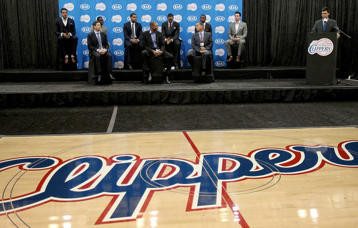 Clippers executives, head coach Doc Rivers, front center, and players take the stage during a news conference at the team's practice facility in Los Angeles.