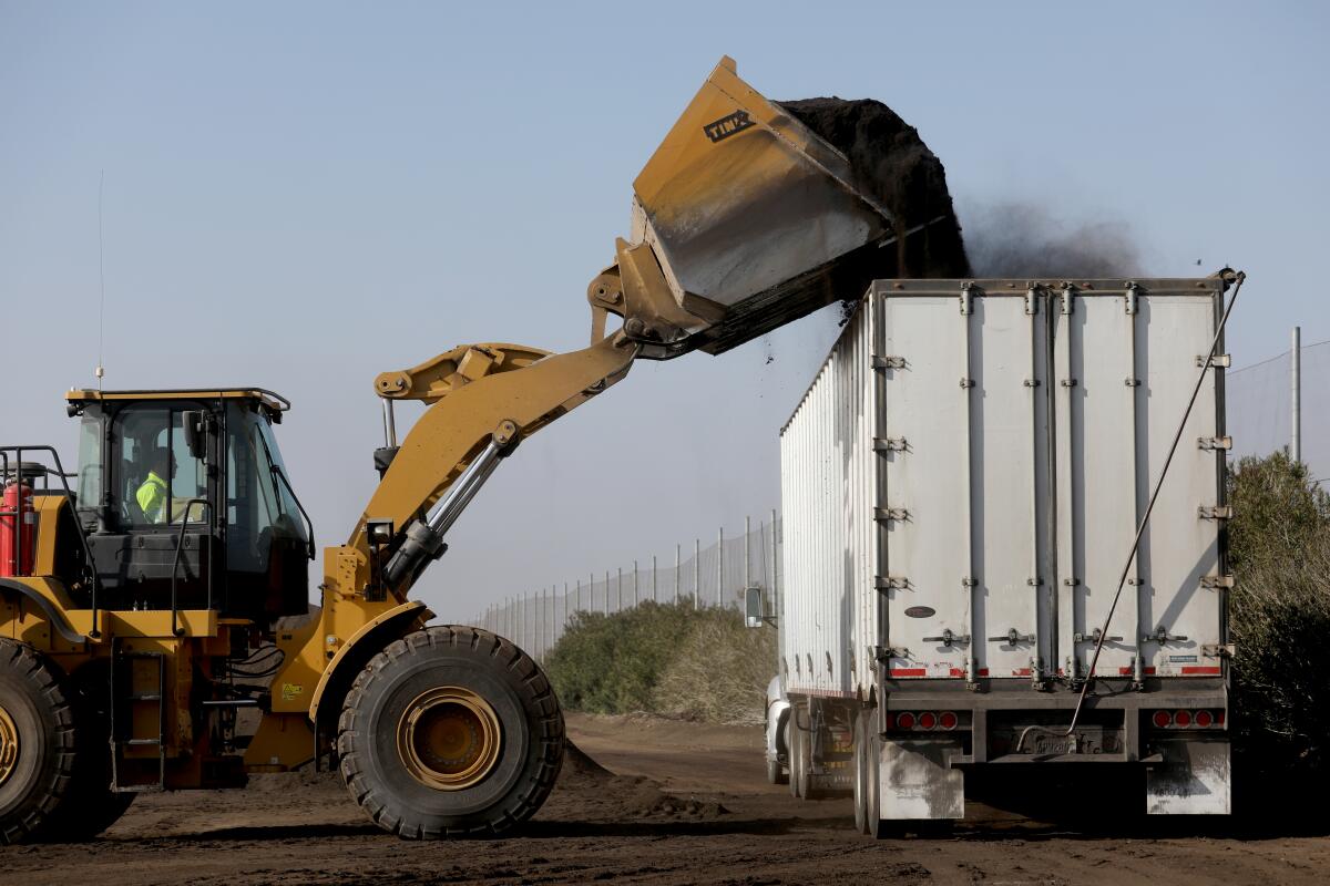 A tractor loads feed stock compost for a customer at   Recology Blossom Valley Organics  