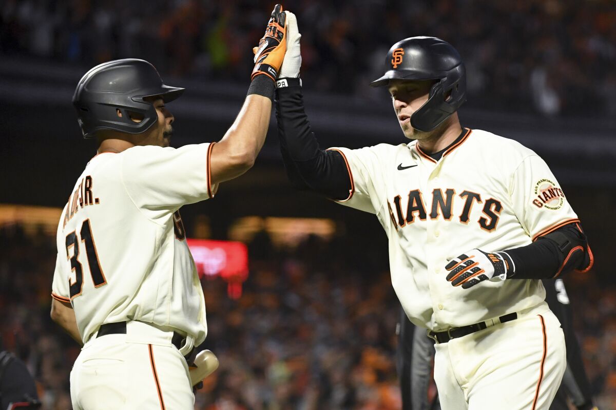 San Francisco's Buster Posey, right, celebrates with LaMonte Wade Jr. after hitting a two-run home run.