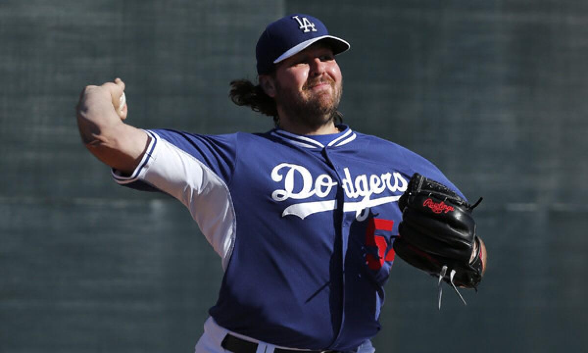 Dodgers pitcher Chris Perez throws during a spring-training practice session on Feb. 11. Perez threw a perfect fifth inning in Tuesday's 4-1 Cactus League loss to the Seattle Mariners.