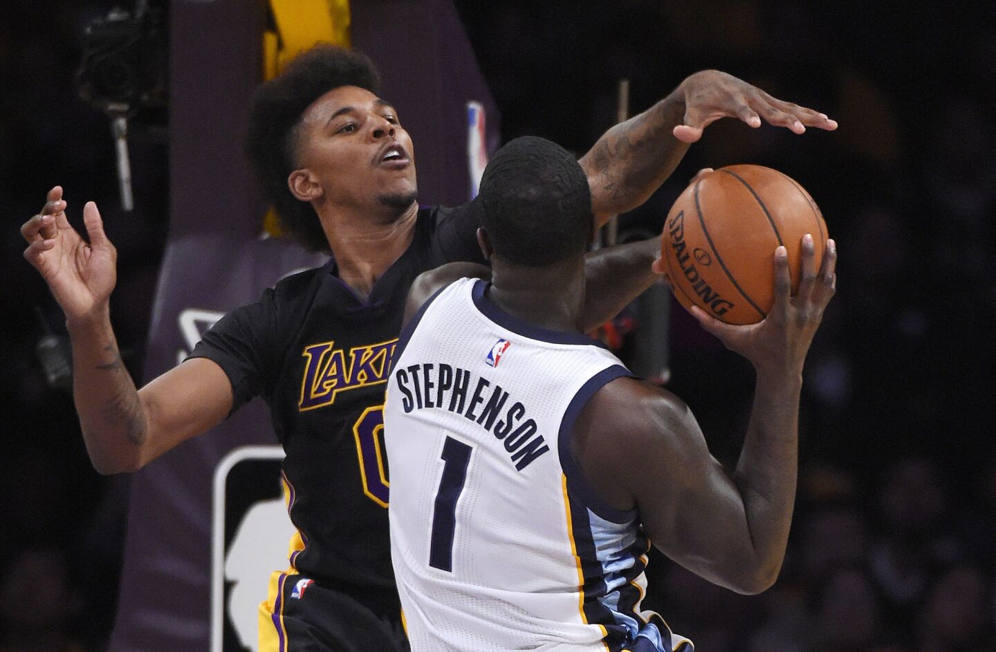 Lakers forward Nick Young, left, blocks a shot from Memphis forward Lance Stephenson during the first half of a game on Feb. 26 at Staples Center.