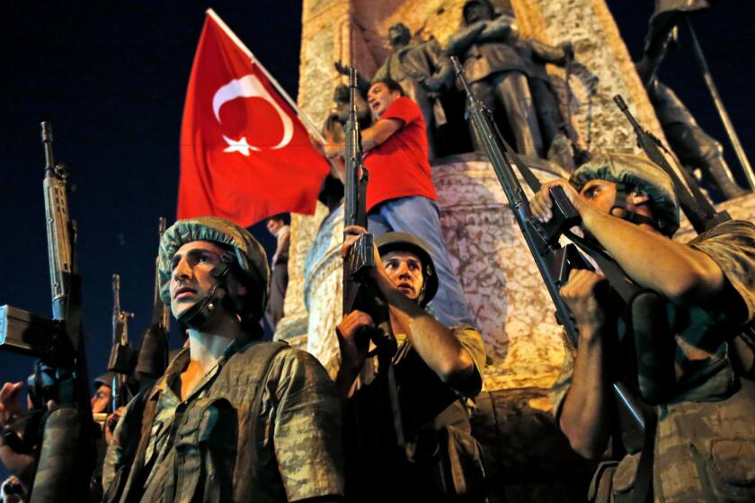 Turkish soldiers secure the area as supporters of President Recep Tayyip Erdogan protest in Istanbul's Taksim square on July 16, 2016.