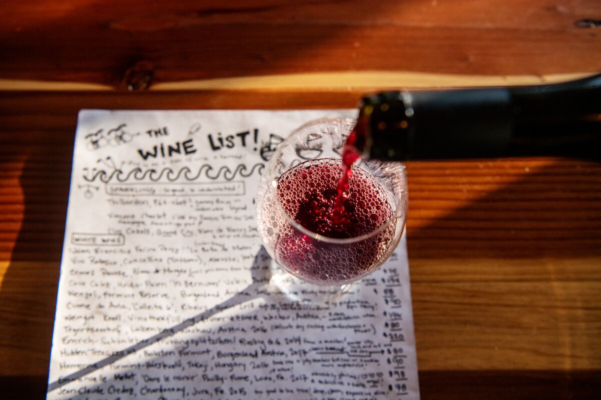 All Time co-owner Ashley Wells hand-writes the frequently changing wine list .