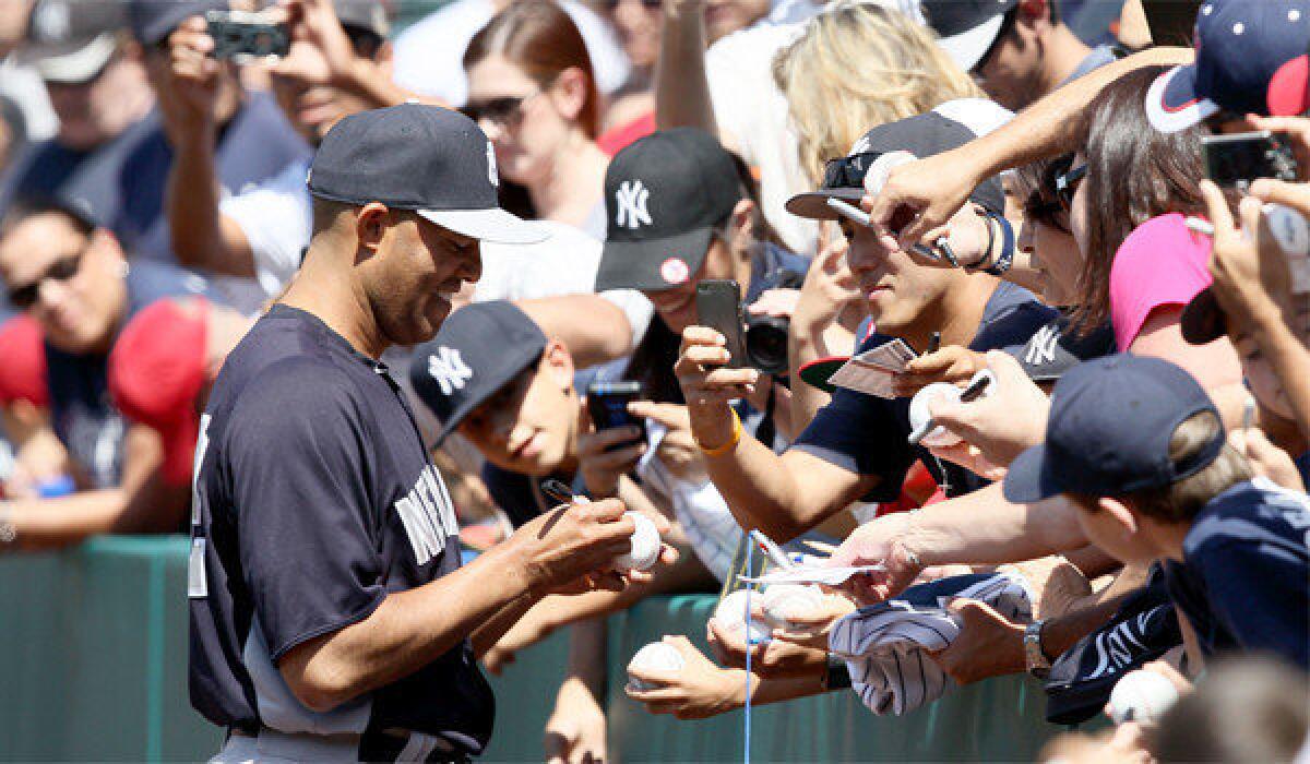New York Yankees closer Mariano Rivera signed autographs for fans at Angel Stadium before Saturday's game.
