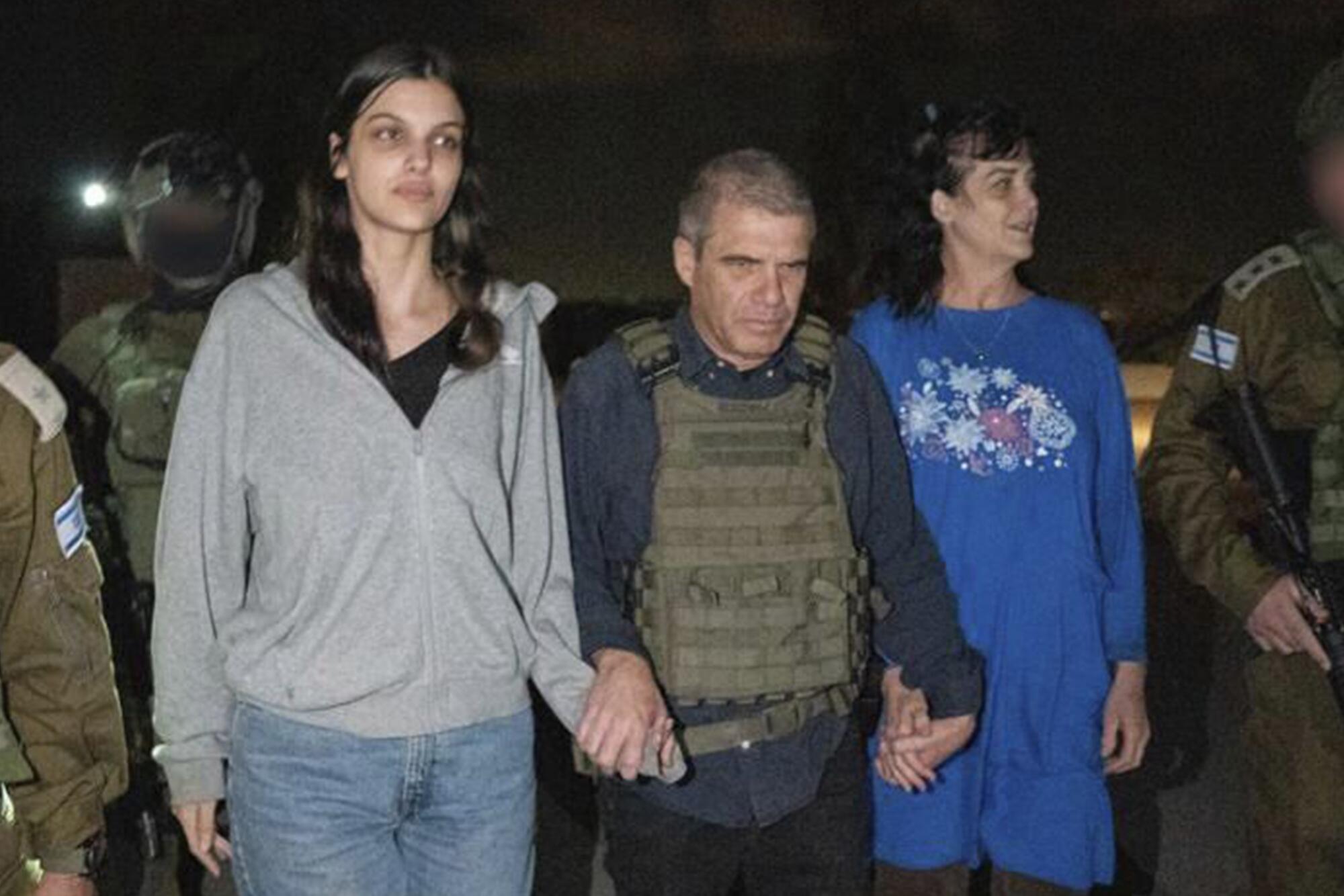 American woman and her teenage daughter with Israeli official after their release from captivity in Gaza.