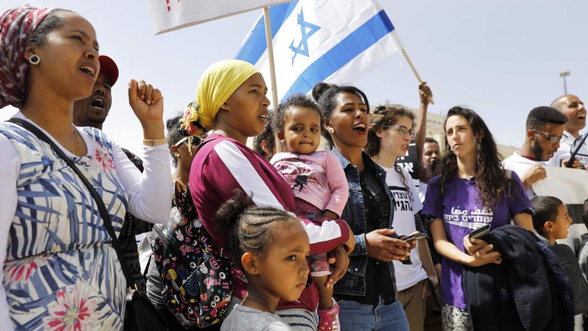 African migrants and Israelis demonstrate April 3 outside the prime minister's office in Jerusalem.